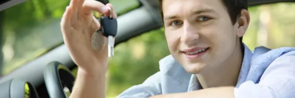 Teen looking out the driver's window holding keys