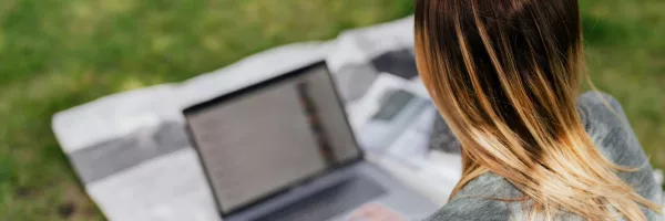 girl studying on laptop outside